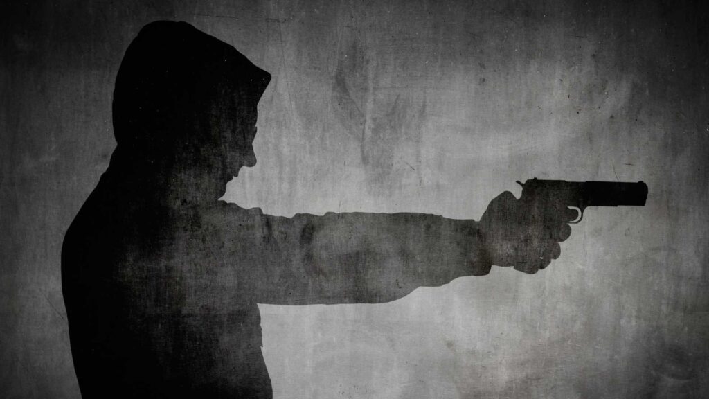 Silhouette Of A Person Holding A Gun