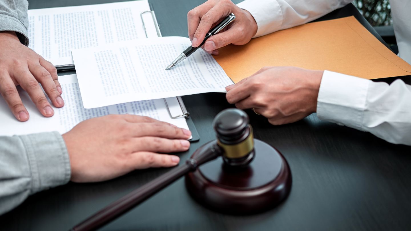 Signing Legal Documents With Gavel On Table