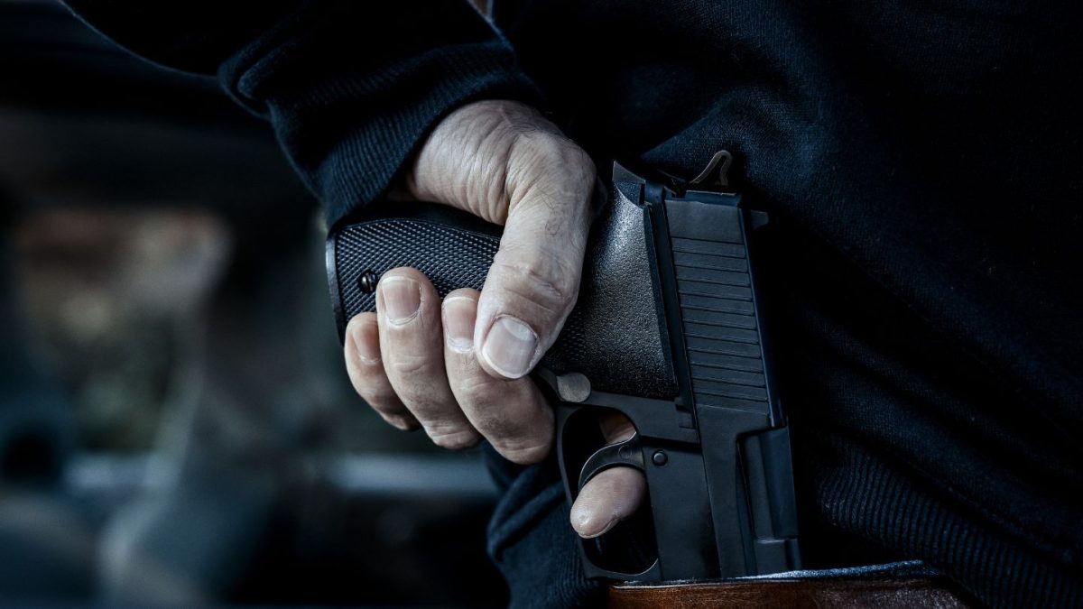 A Person Holding a Handgun